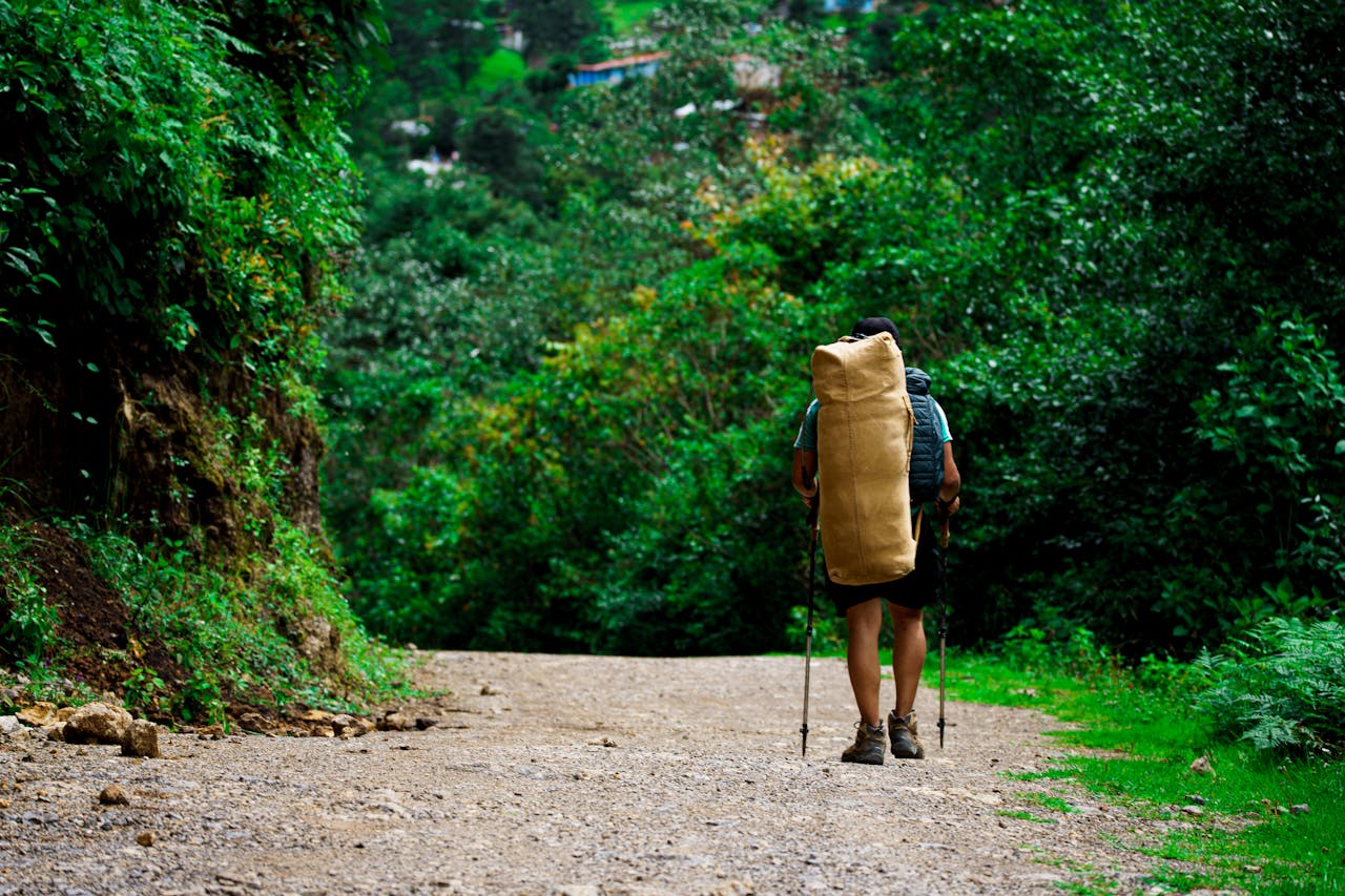Mastering the First Impression: Your intriguing post title goes here Traveler with backpack hiking on lush green trail in Nebaj, Guatemala.